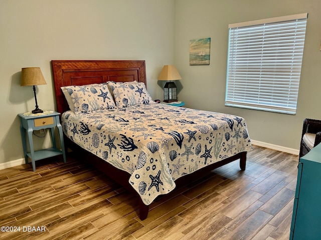 bedroom with hardwood / wood-style flooring