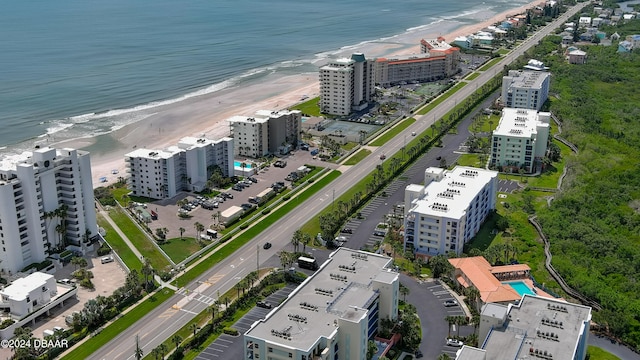 birds eye view of property with a beach view and a water view