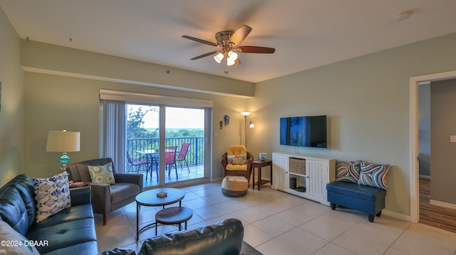 living room featuring ceiling fan and light tile patterned floors