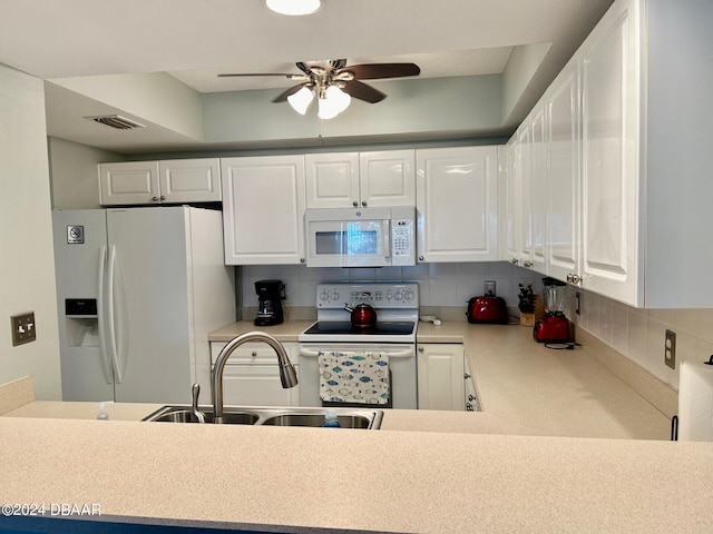 kitchen featuring white cabinetry, sink, white appliances, and backsplash