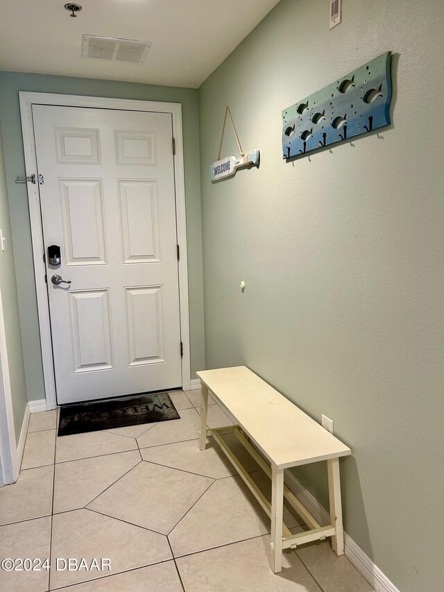 entryway with light tile patterned floors