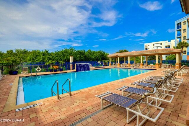 view of swimming pool with a patio area and pool water feature