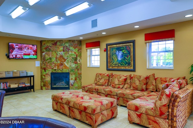 tiled living room featuring a fireplace and a wealth of natural light