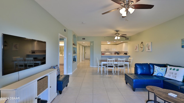 living room featuring ceiling fan and light tile patterned floors