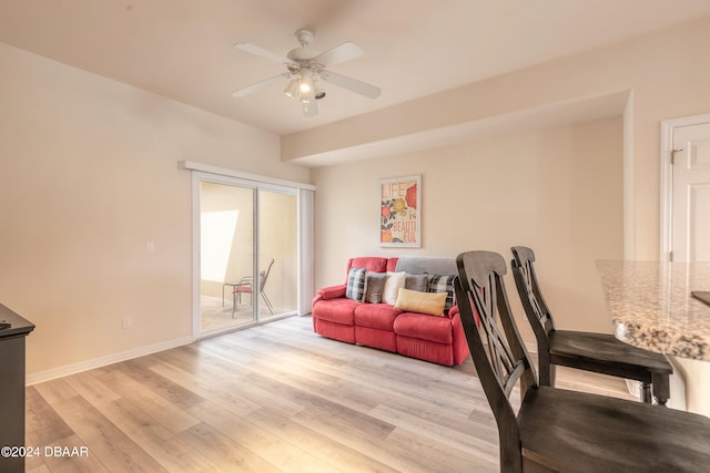 living room with ceiling fan and light hardwood / wood-style floors