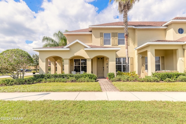 mediterranean / spanish-style house featuring a front yard