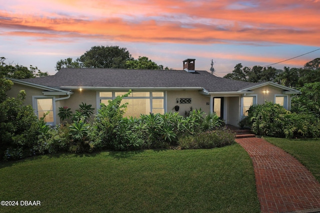 view of front of home with a lawn