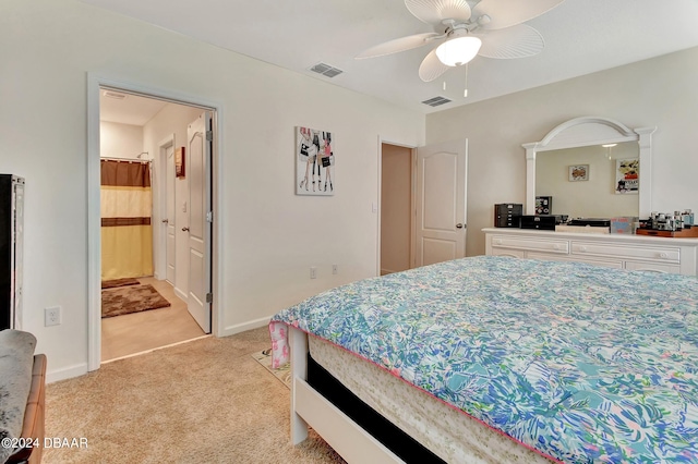 carpeted bedroom featuring ceiling fan and ensuite bathroom