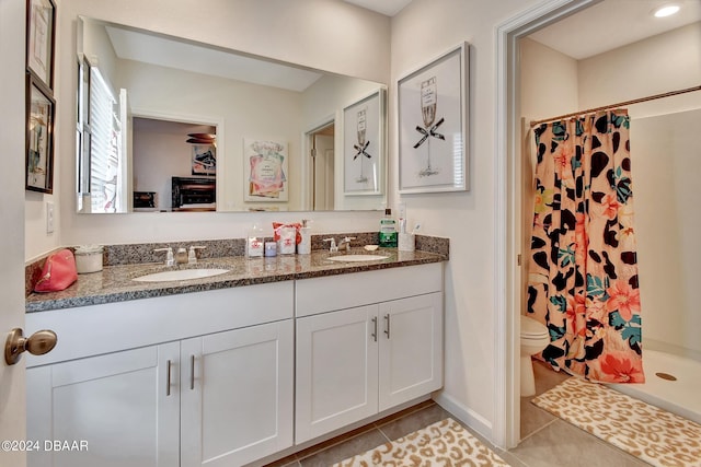 bathroom featuring toilet, vanity, tile patterned floors, and walk in shower