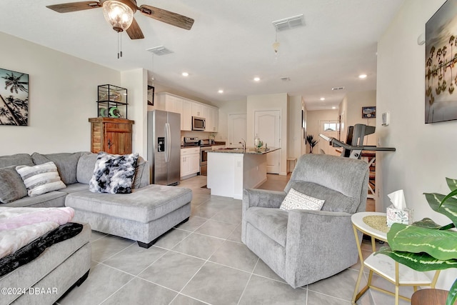 living room with light tile patterned floors and ceiling fan