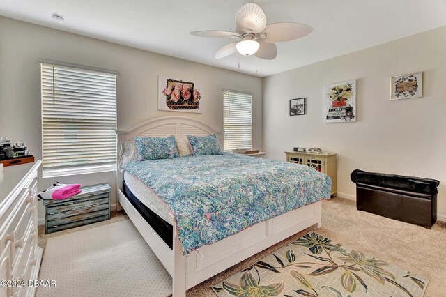 bedroom with light carpet and ceiling fan