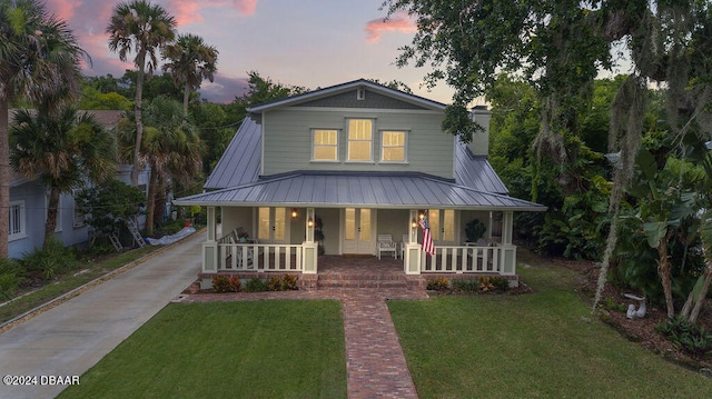 view of front of property featuring a lawn and covered porch