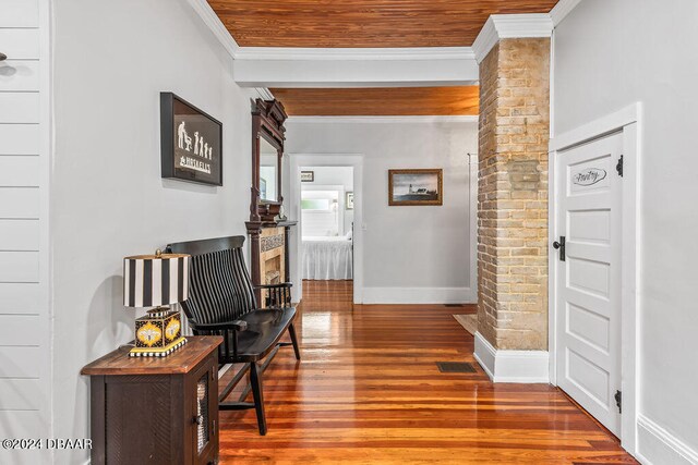 509 Faulkner St, New Smyrna Beach, FL 32168 - hallway featuring ornate columns, hardwood / wood-style floors, and ornamental molding