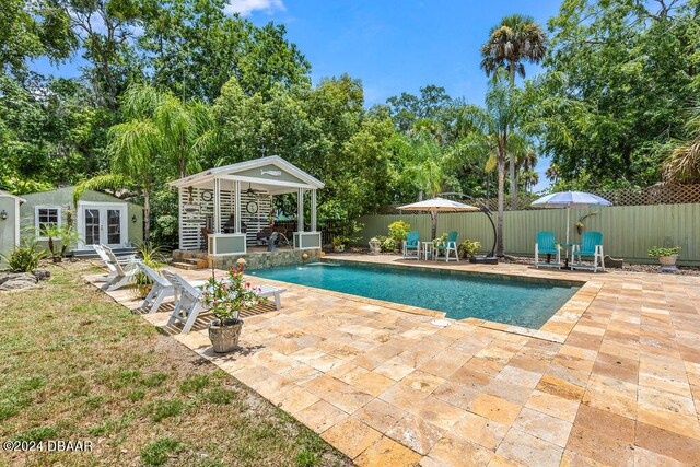 509 Faulkner St, New Smyrna Beach, FL 32168 - view of pool featuring a patio, pool water feature, and french doors