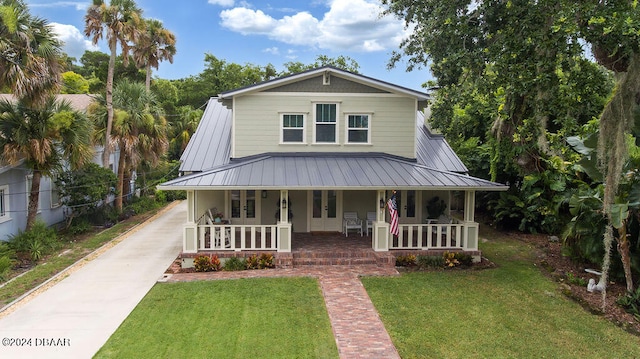 509 Faulkner St, New Smyrna Beach, FL 32168 - view of front of home featuring a porch and a front yard