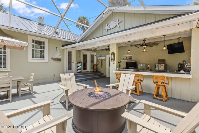 509 Faulkner St, New Smyrna Beach, FL 32168 - view of patio / terrace featuring an outdoor bar, an outdoor fire pit, a lanai, and ceiling fan