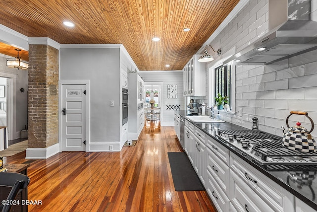 509 Faulkner St, New Smyrna Beach, FL 32168 - kitchen featuring wooden ceiling, sink, ornamental molding, wall chimney exhaust hood, and dark hardwood / wood-style flooring