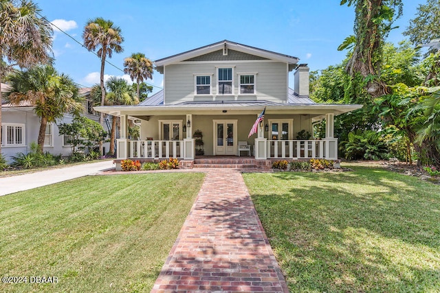 509 Faulkner St, New Smyrna Beach, FL 32168 - view of front of home featuring a porch and a front lawn