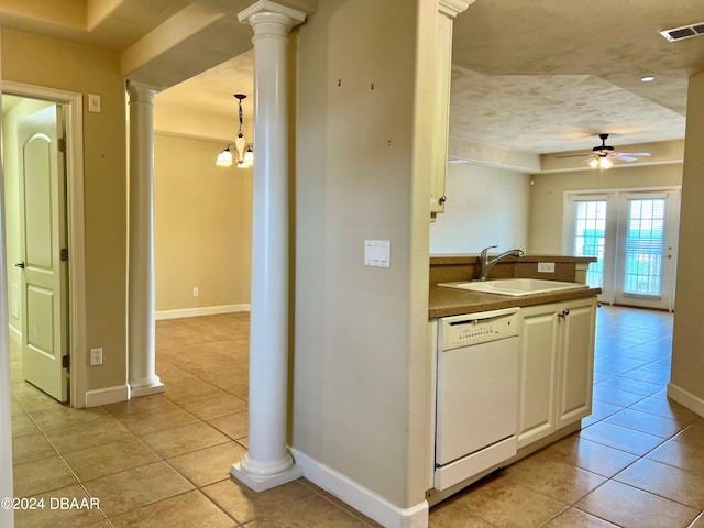 kitchen with ceiling fan with notable chandelier, dishwasher, sink, light tile patterned floors, and pendant lighting