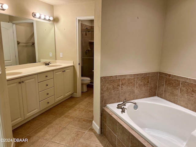 full bathroom featuring tile patterned flooring, shower with separate bathtub, vanity, and toilet