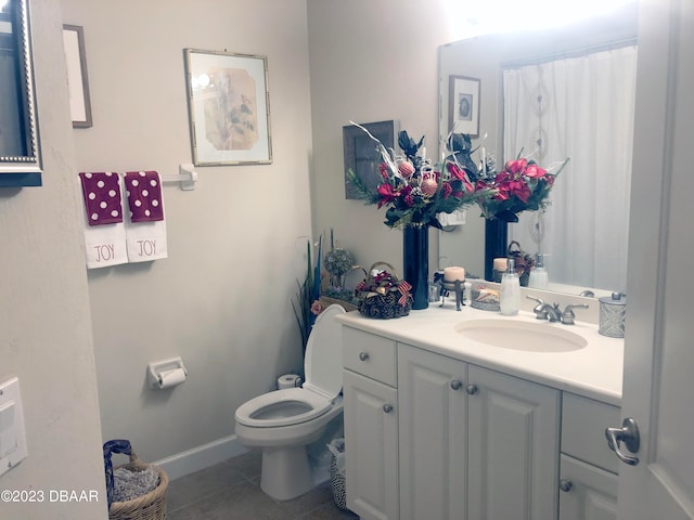 bathroom featuring toilet, vanity, and tile patterned floors