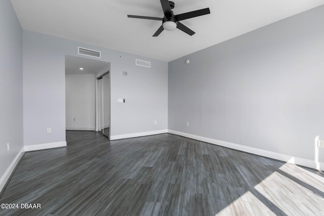 spare room featuring dark hardwood / wood-style floors and ceiling fan