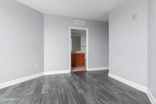 empty room with dark hardwood / wood-style flooring