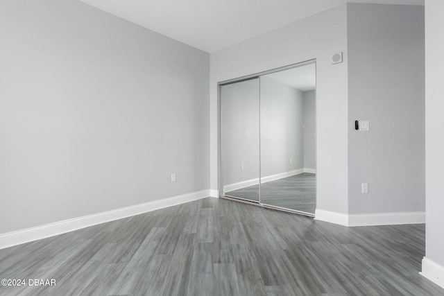 unfurnished bedroom featuring a closet and wood-type flooring