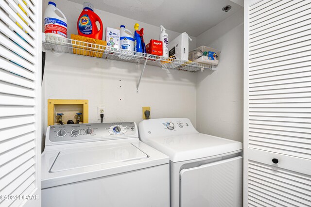 clothes washing area featuring separate washer and dryer