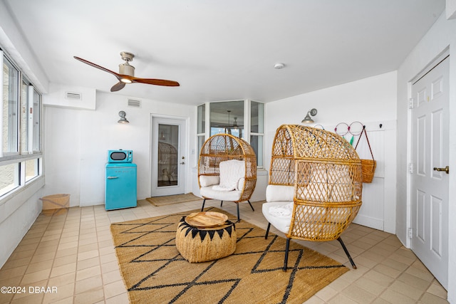 sitting room with light tile patterned flooring and ceiling fan