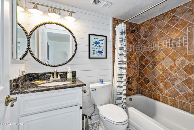 full bathroom with toilet, shower / tub combo with curtain, vanity, and wooden walls