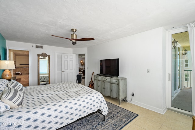 bedroom featuring light tile patterned flooring, a textured ceiling, ceiling fan, and a closet