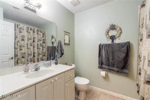 bathroom featuring tile patterned flooring, vanity, and toilet