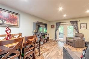 living room with light hardwood / wood-style flooring and french doors