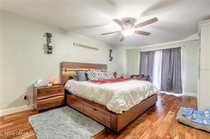 bedroom with wood-type flooring and ceiling fan