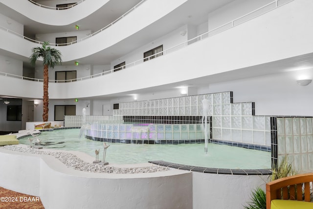 view of pool featuring a hot tub and pool water feature