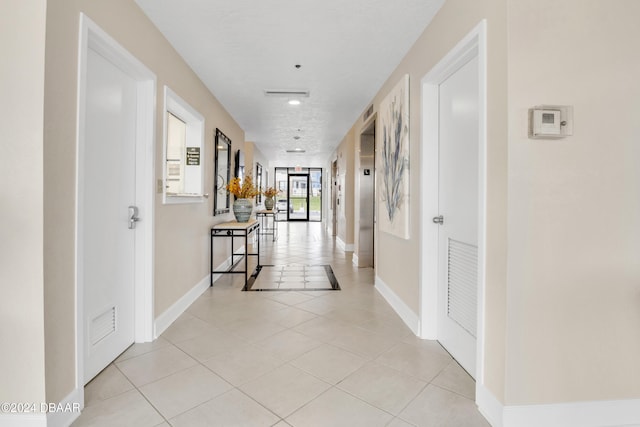 corridor with light tile patterned flooring