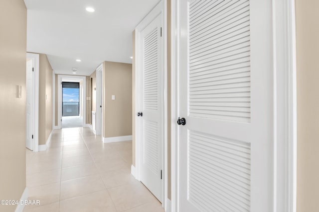 hall with light tile patterned floors