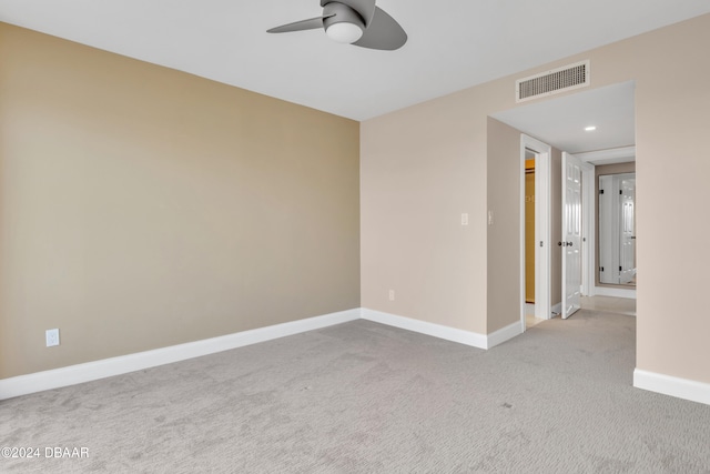 carpeted spare room with ceiling fan