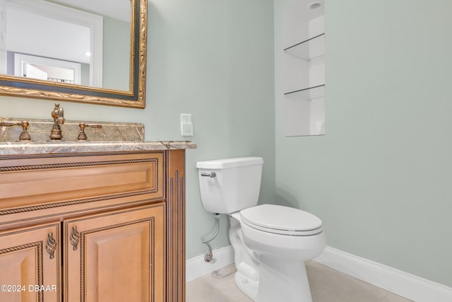 bathroom with vanity, tile patterned flooring, and toilet