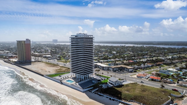 birds eye view of property with a view of the beach and a water view