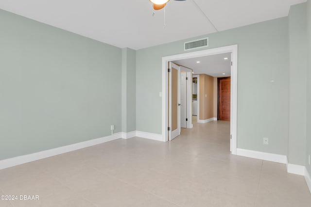 spare room featuring ceiling fan and light tile patterned floors