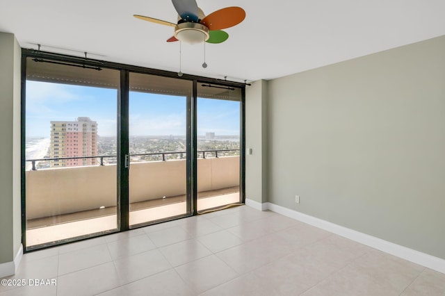 2200 N Atlantic Ave Unit 1602, Daytona Beach, FL 32118 - spare room with a wall of windows, baseboards, a ceiling fan, a view of city, and tile patterned flooring