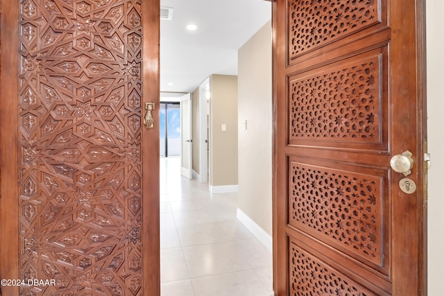 hall with light tile patterned floors