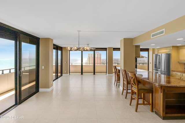 2200 N Atlantic Ave Unit 1602, Daytona Beach, FL 32118 - dining area with light tile patterned flooring, floor to ceiling windows, a chandelier, baseboards, and visible vents