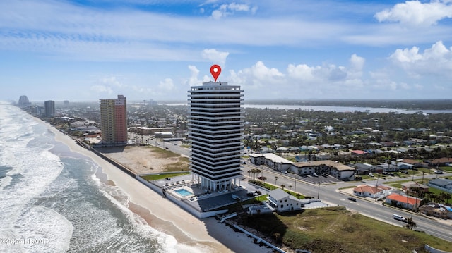 aerial view with a water view and a beach view