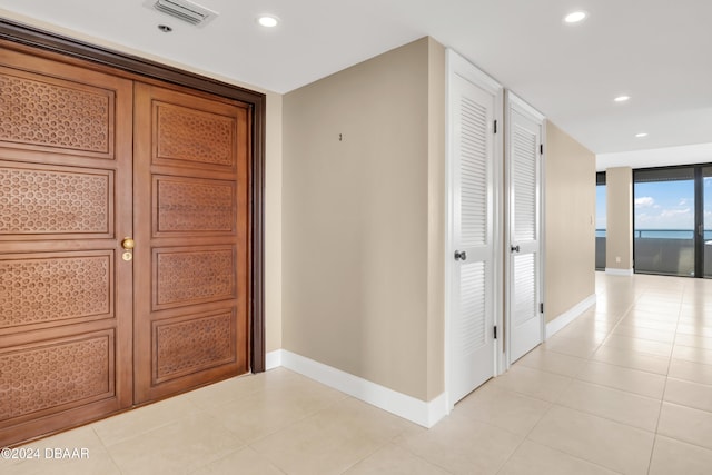 corridor featuring light tile patterned floors