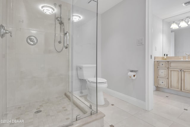 bathroom featuring vanity, tile patterned floors, toilet, and a shower with door