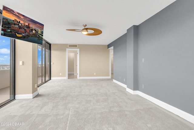 empty room featuring light carpet and ceiling fan