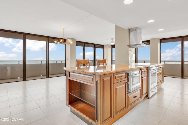 kitchen featuring a center island, a chandelier, oven, pendant lighting, and range hood